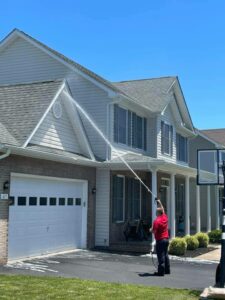 Extra Mile Power Washing pressure washing a home in the Bunker Hill, WV area.