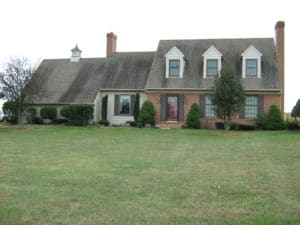 Black stains on roof before pressure washing by Extra Mile Powerwashing